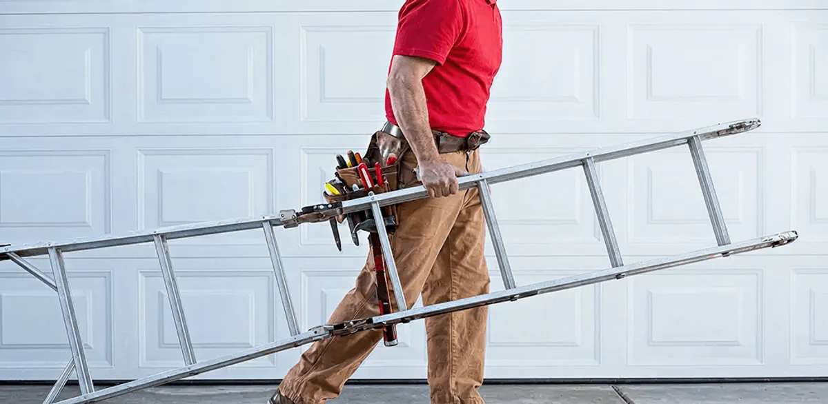 Garage door repair technician arriving with tools and ladder in Sioux Falls, SD